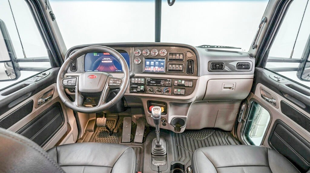 Peterbilt 389X cab interior showing the dashboard, steering wheel, and driver's seat